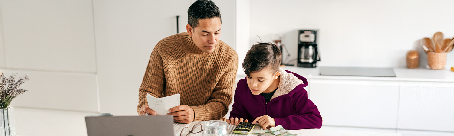 Parent showing his child how to manage bills